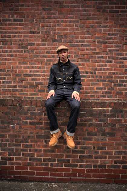 What We Wore Project with Nina Manandhar; man seated on brick wall