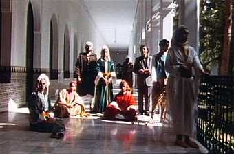 film still of Matisse in Tangier. Showing people standing and sitting in a corridor