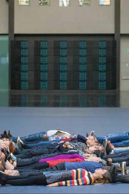 people lying down on the Turbine hall floor facing up