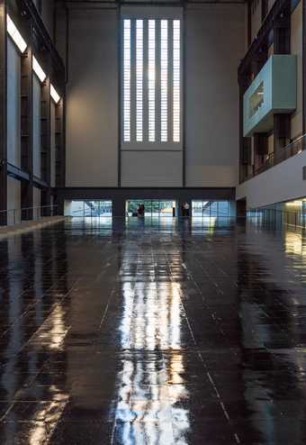 Photograph of the empty Turbine Hall at Tate Modern with its temporary glossy black floor during Tania Bruguera's Hyundai Commission