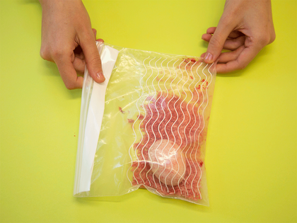 gif of a bag with red rice and an egg inside it being shaken around