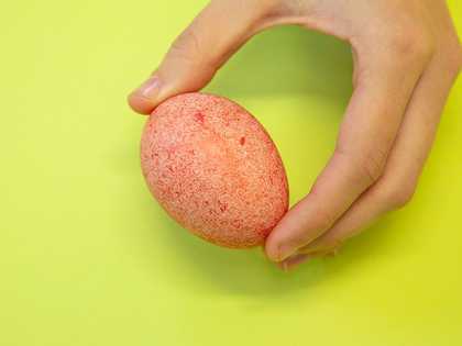 Holding up the final red speckled egg