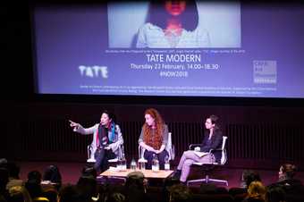 Three women onstage as part of a conference panel