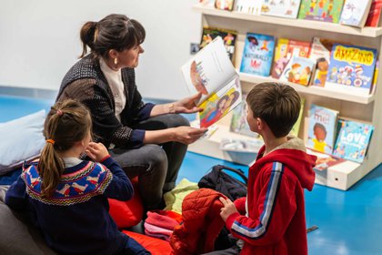 Mother reading to two kids 