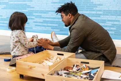 Man playing with his child in the Learning Gallery at Tate Britain
