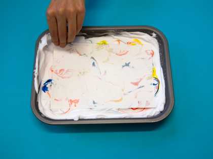 Hand about to pull paper off the foam