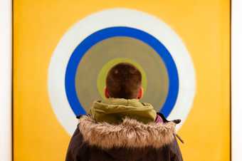 person looking at a painting
