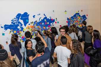 Photograph of young people interacting with a map at the Tate Modern opening