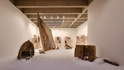 gallery with objects on a floor covered in salt