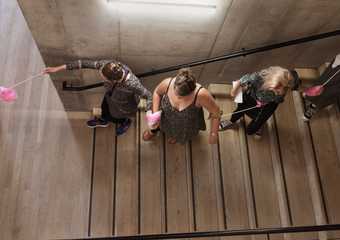 A group of teachers walking down a flight of stairs