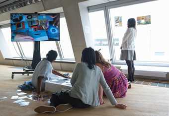 A group of people using an overhead camera