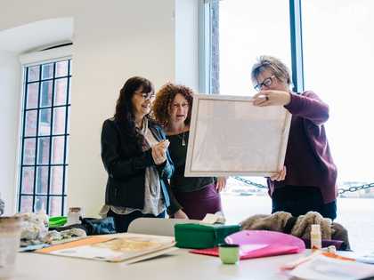 People looking at an art work during a workshop.