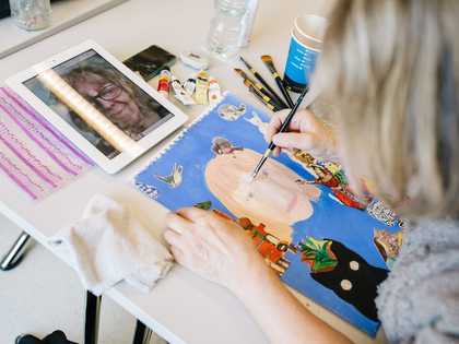 A person painting at Tate Liverpool