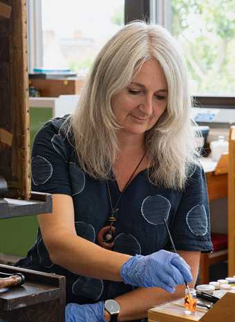 Paintings conservator Susan Breen at work in the conservation studio at Tate Britain, 2020