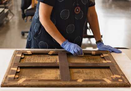Photograph of a conservator at work at Tate
