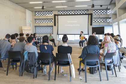 People sit in a circle listening to a Tate Intensive group