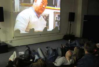 Local residents watching a film screening