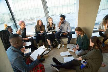 A group of people sitting in a circle