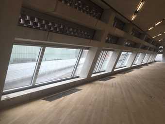 Photograph of part of the floor and windows in the Tate Exchange space at Tate Modern, empty