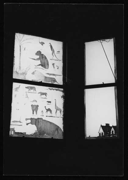 Photograph of a blackout window with carvings