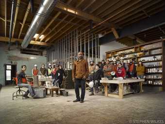 portrait of Theaster Gates and other people in his studio