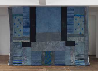 An artwork of patchwork textiles in shades of blue