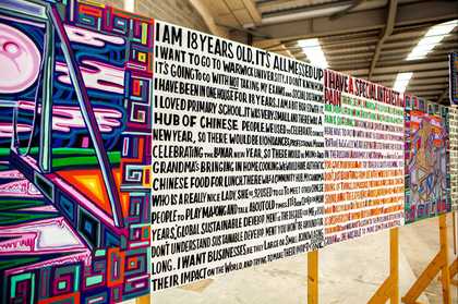 close up of a series of text based paintings on wooden slats