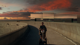 A man riding a scooter in a dystopian landscape