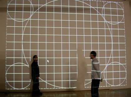Time-based media conservation technicians checking the alignment of an LCD projector