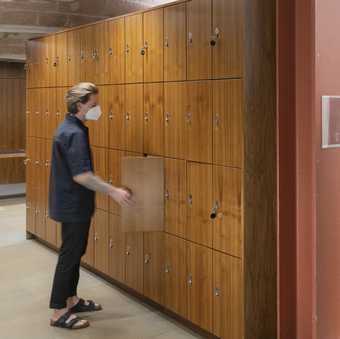 Person opening a locker at Tate Liverpool.