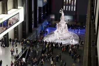 photograph of lots of people in the Turbine Hall with a big monument sculpture 