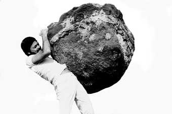 a man holds a rock
