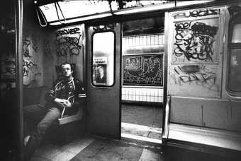 Photograph of Keith Haring in a New York subway car