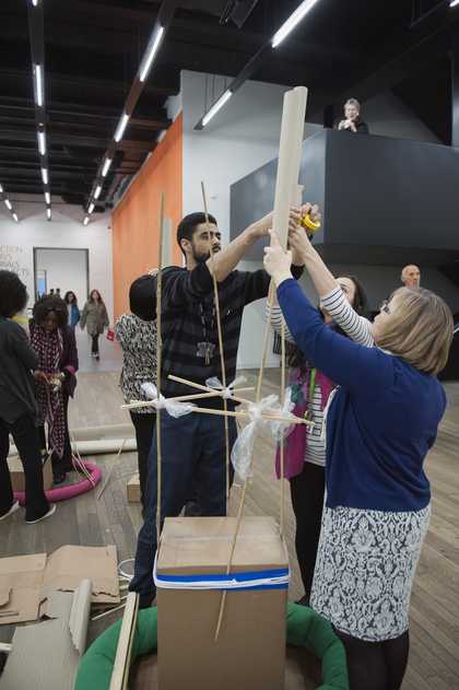 Two people building a sculpture