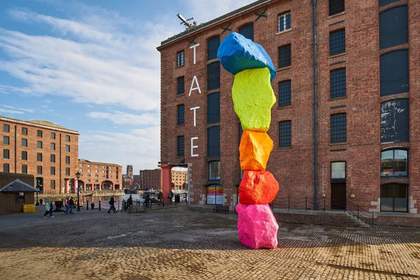 five large bright coloured stacked like a totem