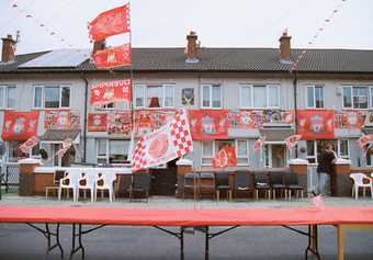 A row of houses adorned with Liverpool flags