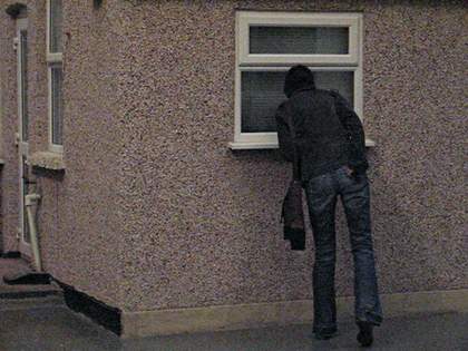 Video still of spectators looking at Michael Landys installation Semi detached at Tate Britain two