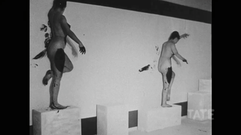 Still image from film of performance to create Klein's Anthropometry paintings