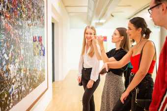 A group stood looking at a piece of art