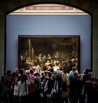 Visitors crowding around Rembrandt's The Night Watch at the Rijksmuseum in Amsterdam - Koen van Weel/AFP/Getty Images