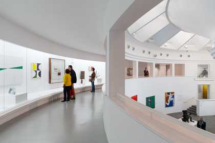 visitors stand and look in the curved gallery in st ives