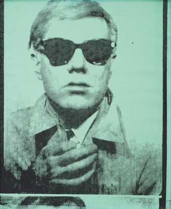 Portrait in green and black of Andy Warhol wearing sunglasses