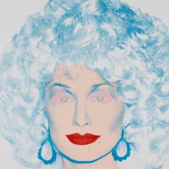 Dolly Parton pictured with blue hair and red lipstick