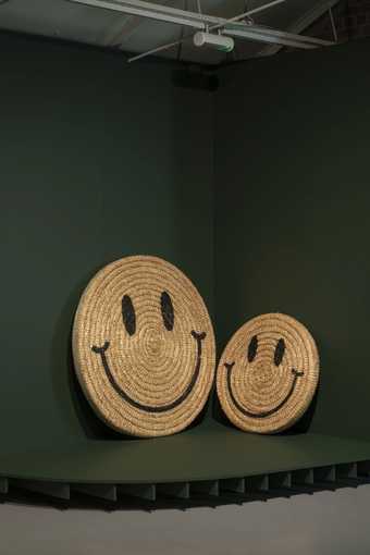 Two large wicker smiley faced objects