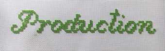 The word production embroidered in green thread