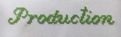 The word production embroidered in green thread