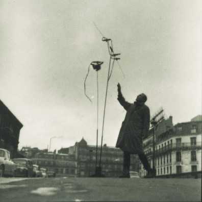 Takis lighting his Firework Signal (Signaux feux d’artifice) in front of Montparnasse Station, Paris, 1957. Photo: Martha Rocher