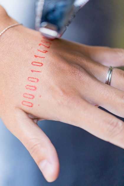 Numbers printed on a hand from Tania Brugera's Turbine Hall project