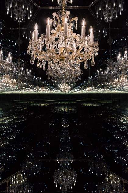 A chandelier reflected in dark mirrors to infinity