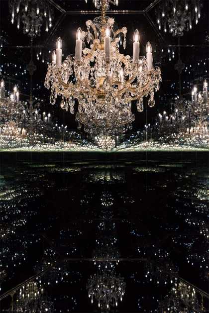 A chandelier reflected in dark mirrors to infinity
